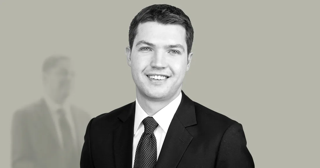 Black and white team headshot over a faded office
