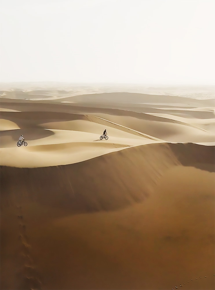 Film production still — lone figure walking desert dunes, Entrepreneurship World Cup