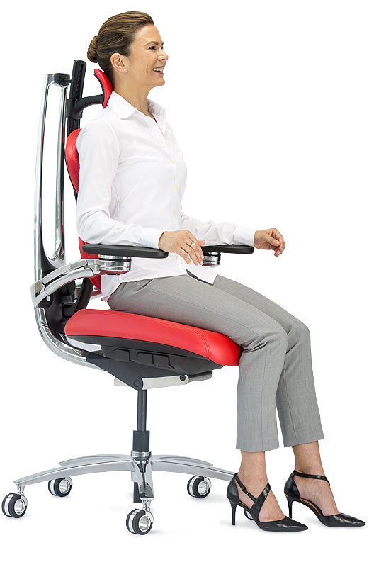 Product photography — woman seated on a red MUUV ergonomic chair, white background